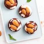 A close up of keto almond joy candies, topped with two almonds.