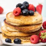 Almond flour pancakes topped with blueberries and raspberries.