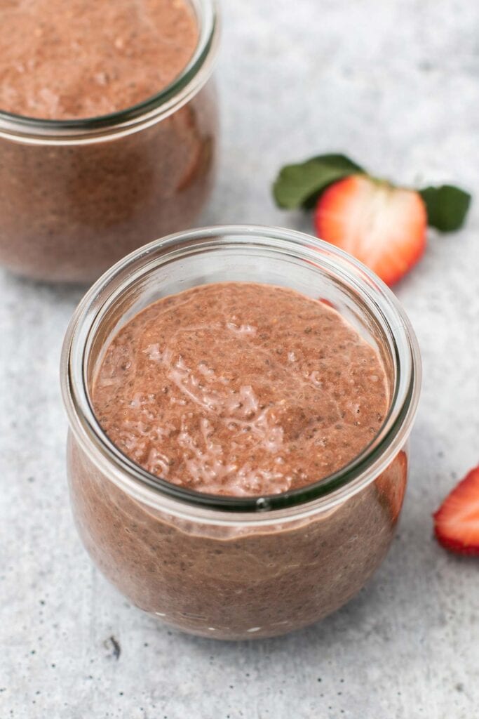Jars filled with keto chia pudding showing the thick and creamy texture.