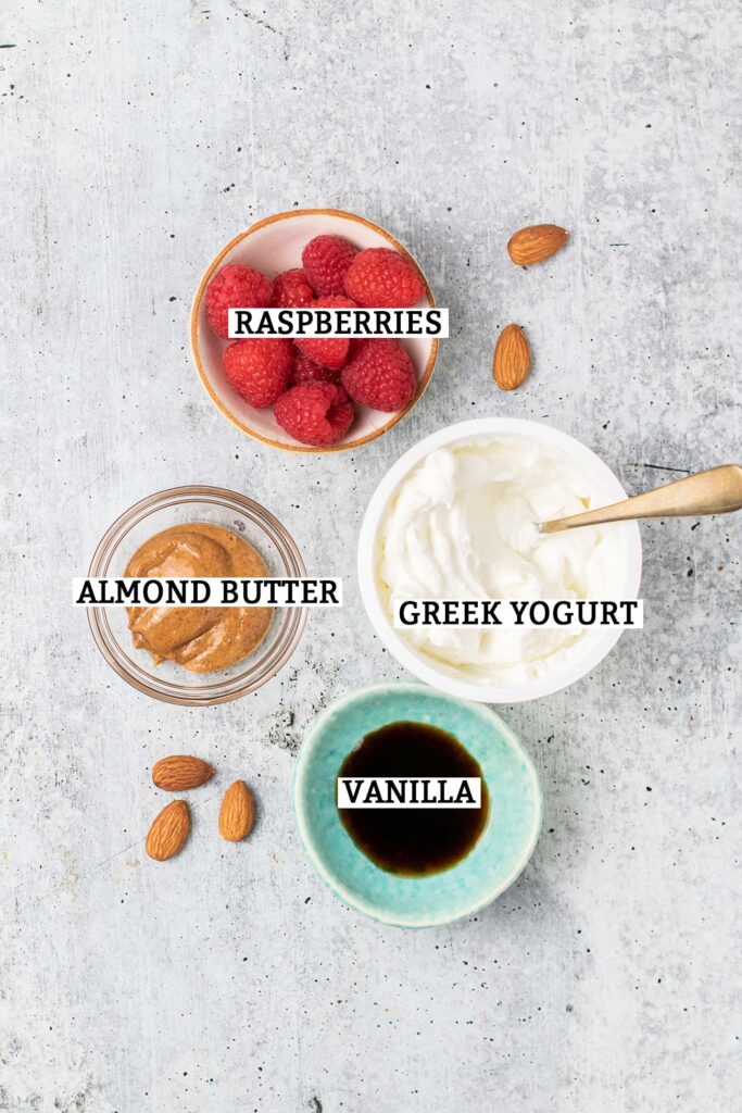 A greek yogurt with raspberries, almond butter, and vanilla.