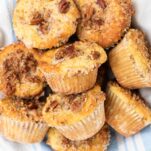 A basket full of basic keto muffins topped with pecans.