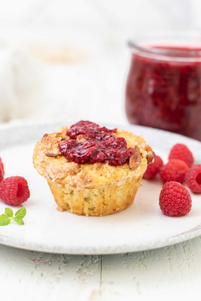 A muffin topped with raspberry jam.