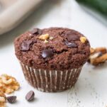 A chocolate muffin studded with dark chocolate chunks and walnuts.