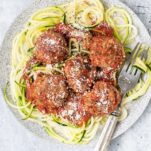 Keto Meatballs shown served over zoodles with marinara sauce.