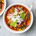 A bowl of keto turkey chili topped with cheese and sour cream.