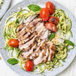 Chicken Zucchini Pasta tossed with pesto and topped with burst tomatoes.