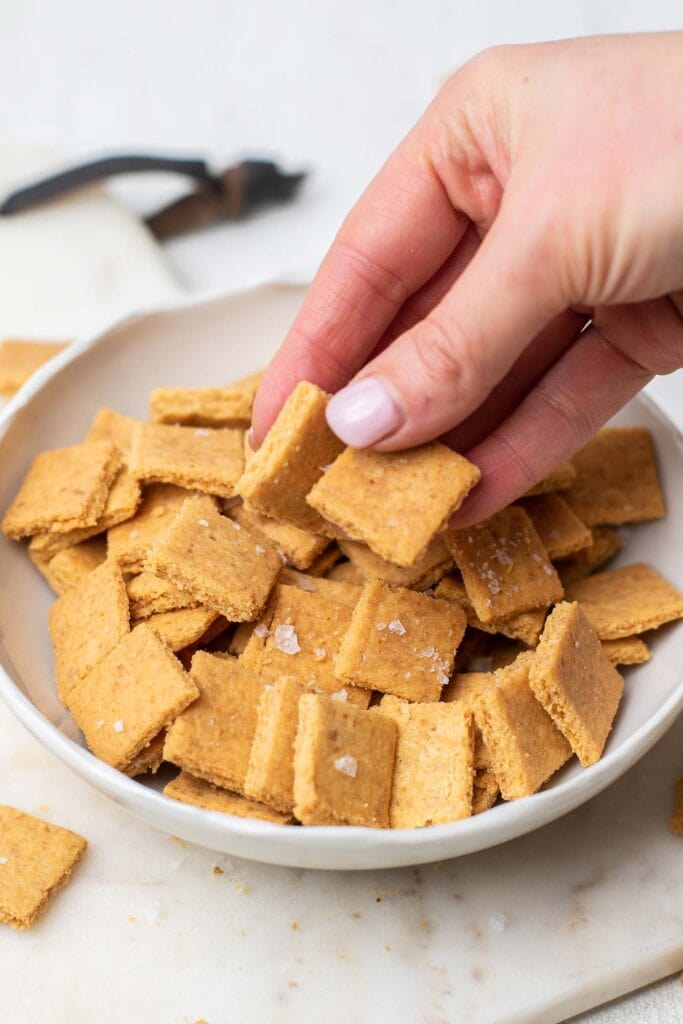 A bowl filled with keto cheez it crackers that are homemade.