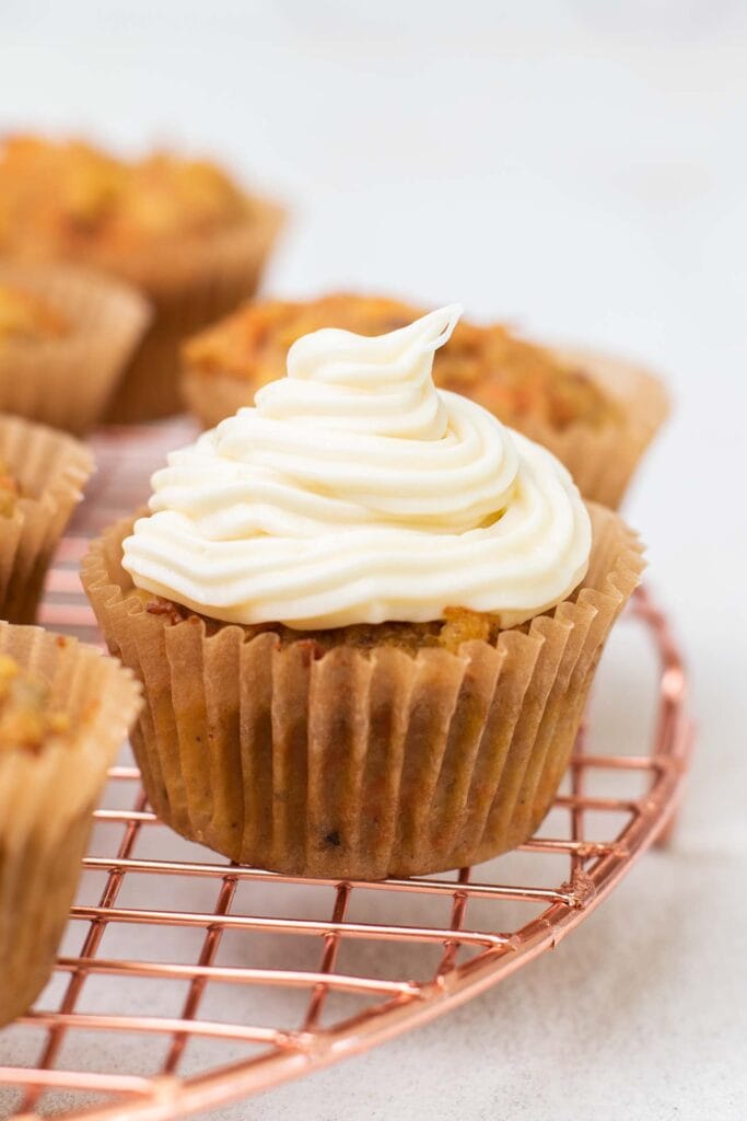 A cupcake topped with keto cream cheese frosting.