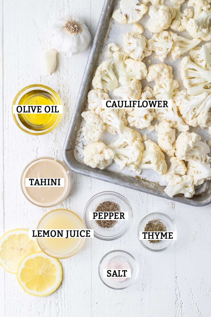 The ingredients needed to make a roasted cauliflower hummus shown with labels.