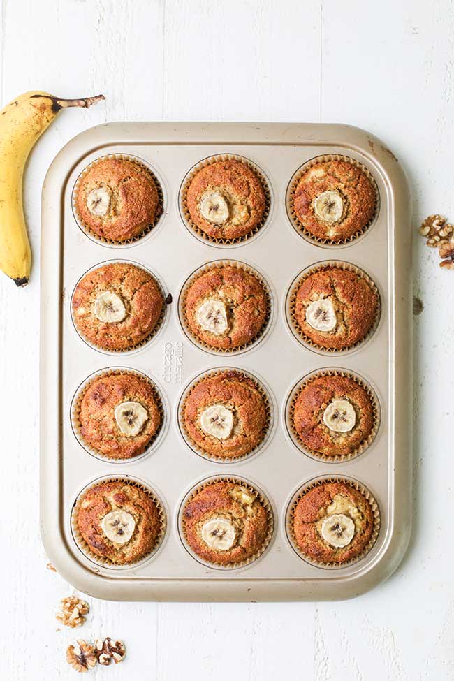 A muffin tin filled with golden brown muffins.