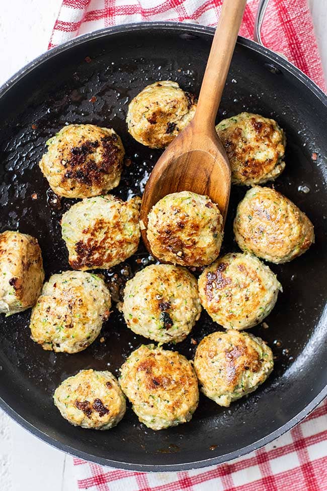 A skillet of caramelized keto chicken meatballs.