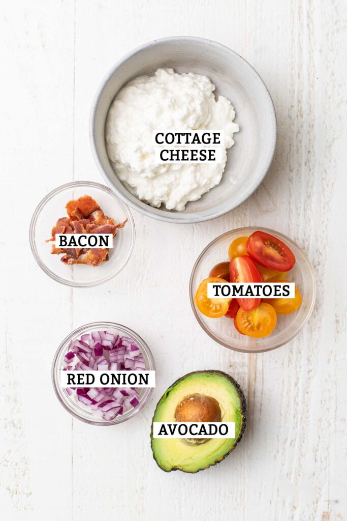 The ingredients needed for a bowl of bacon avocado cottage cheese.