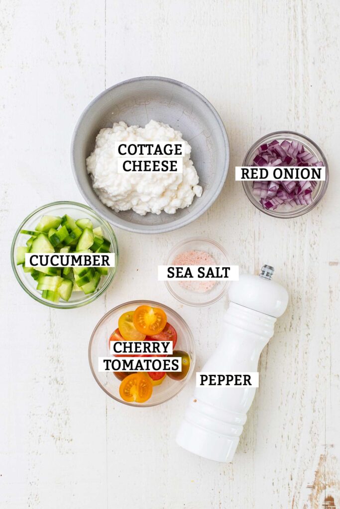 Ingredients in a tomato cucumber cottage cheese bowl.