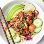 Air fryer salmon bites on top of a asian cabbage salad.